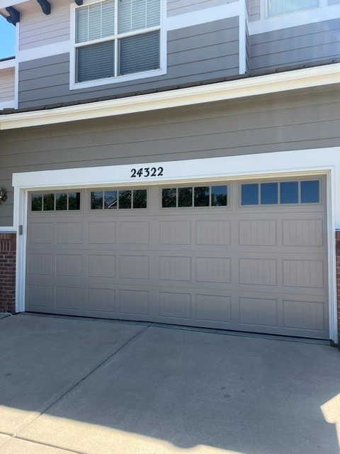 Gray short-panel carriage door with windows