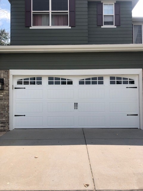 White carriage-house door with arched windows