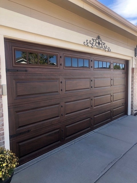 Woodgrain long-panel door with decorative hardware