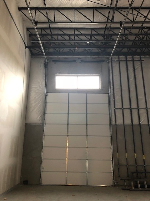 Commercial sectional door with transom window