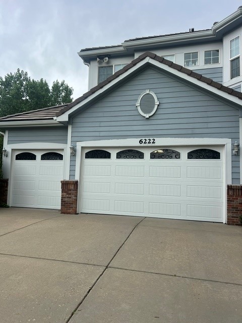 Carriage-house doors with arched tinted windows